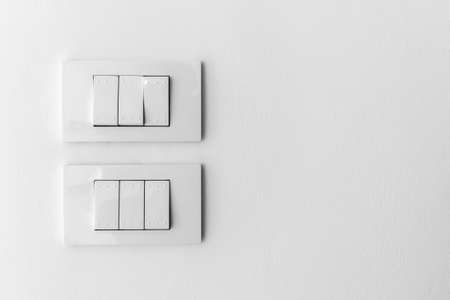 white lighting switch on concrete wall background