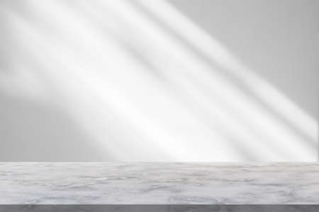 Marble table with window shadow drop on white wall background for mockup product displayの写真素材