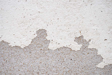 Abstract old white concrete wall with peeling paint