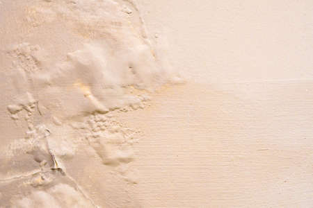 Brown wall damp damaged with peeling paint