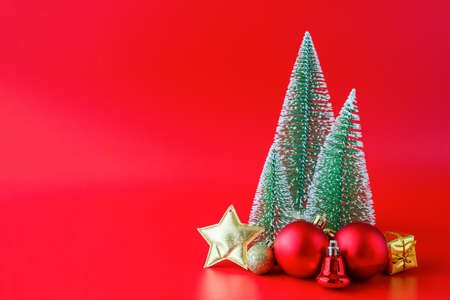 Christmas tree and baubles on red background new year  holiday celebration conceptの写真素材