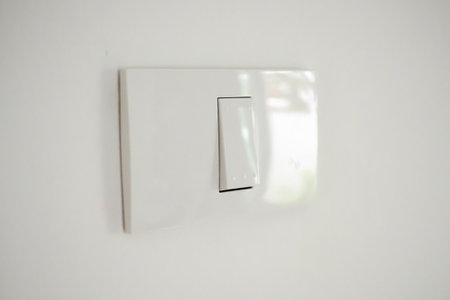 white lighting switch on concrete wall background