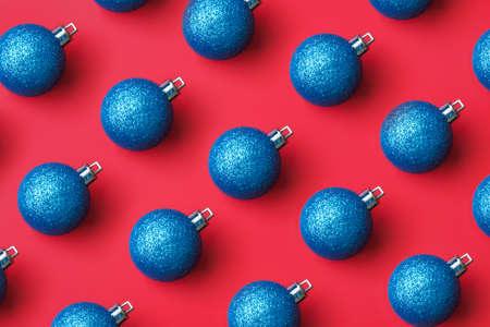 Blue Christmas ball bauble pattern minimal flatlay on red background top viewの写真素材