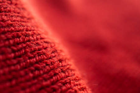 closeup red knitted woolen fabric texture backgroundの写真素材