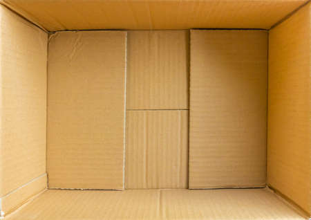 Open empty brown cardboard box background top viewの写真素材