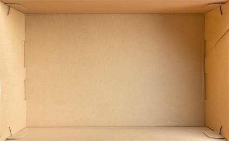 Open empty brown cardboard box background top viewの写真素材