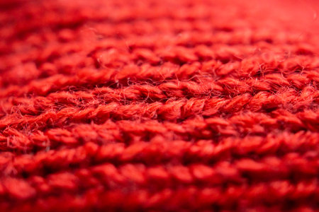 closeup red knitted woolen fabric texture backgroundの写真素材
