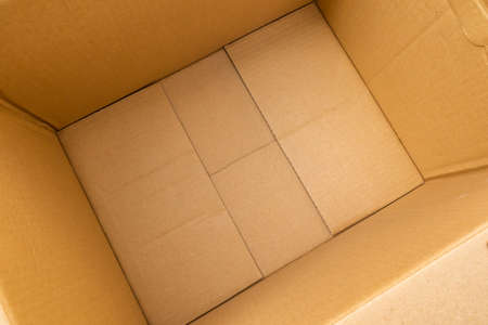 Open empty brown cardboard box background top viewの写真素材