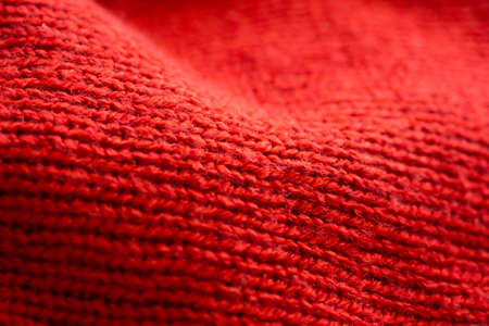 closeup red knitted woolen fabric texture backgroundの写真素材