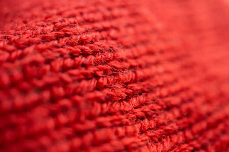 closeup red knitted woolen fabric texture background