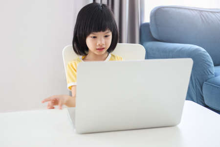 little asian girl student study online using laptop computer at homeの写真素材