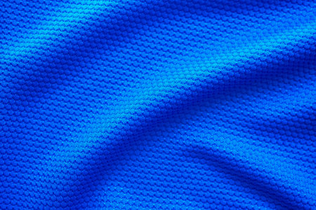Blue football jersey clothing fabric texture sports wear background, close up top view