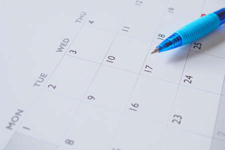 Blue pen on calendar page background business planning appointment meeting concept