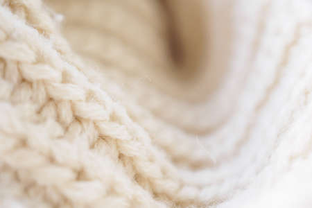 closeup beige knitted woolen fabric texture backgroundの写真素材