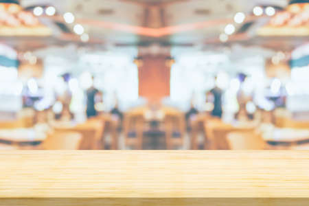 Empty wood table top with cafe restaurant interior blurred background
