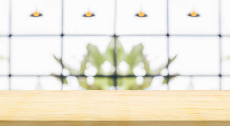 Empty wood table top with cafe restaurant interior blurred backgroundの写真素材