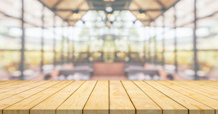 Empty wood table top with cafe restaurant interior blurred background