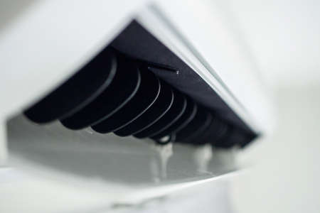 Air conditioner on white wall room interior background