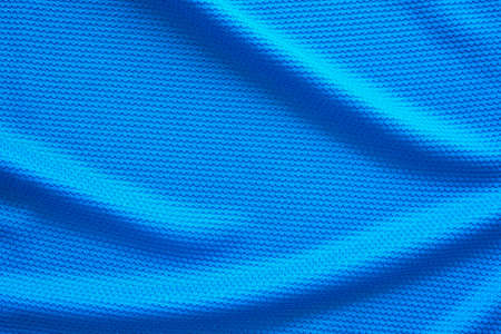 Blue football jersey clothing fabric texture sports wear background, close up top viewの写真素材
