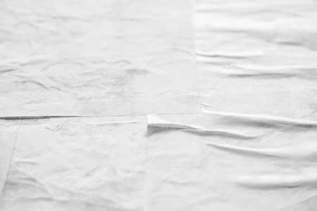 Blank white crumpled and creased paper poster textureの写真素材
