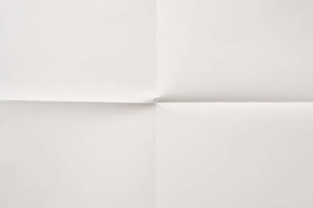White folded and wrinkled paper texture backgroundの写真素材