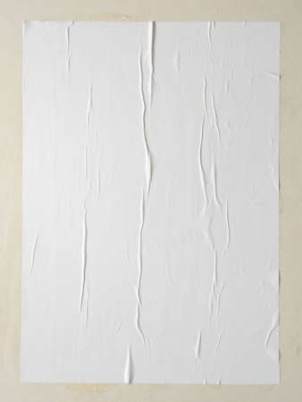 Blank white wheatpaste glued paper poster mockup on white wall backgroundの写真素材
