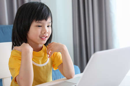 little asian girl student study online using laptop computer at homeの写真素材