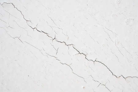 cracked concrete on white wall texture background