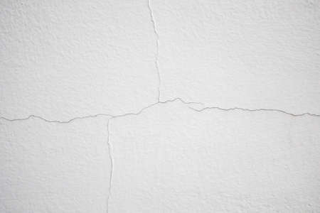 cracked concrete on white wall texture background