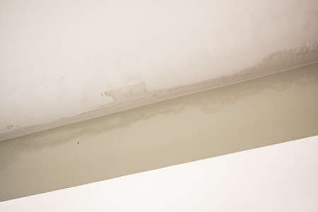 Rain water leak damaged ceiling close up