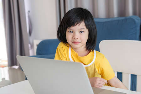 little asian girl student study online using laptop computer at homeの写真素材