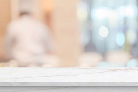 marble table top with blurred kitchen cafe restaurant interior backgroundの写真素材