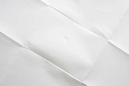 White folded and wrinkled paper texture backgroundの写真素材