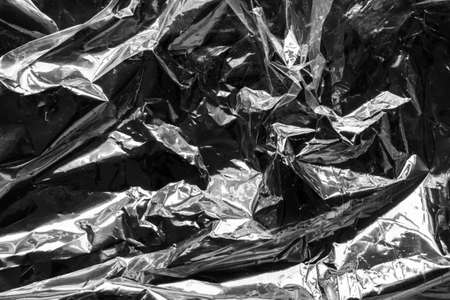 transparent plastic bag film wrap overlay texture on black backgroundの写真素材