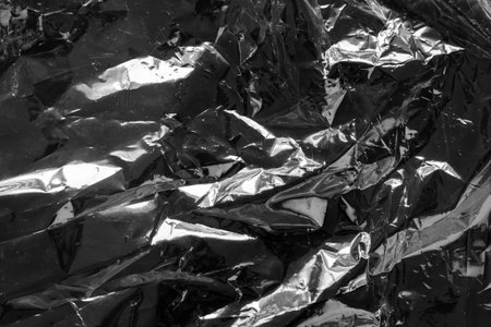 transparent plastic bag film wrap overlay texture on black backgroundの写真素材