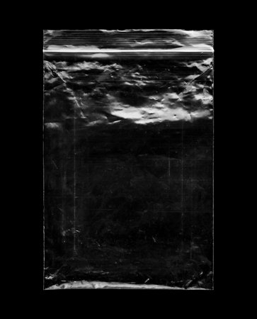 Blank transparent plastic bag overlay on black backgroundの写真素材