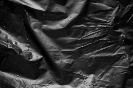 transparent plastic bag wrap overlay texture on black backgroundの写真素材