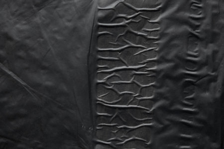 transparent plastic bag wrap overlay texture on black background