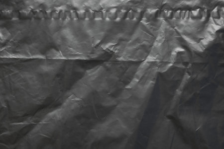 transparent plastic bag wrap overlay texture on black backgroundの写真素材