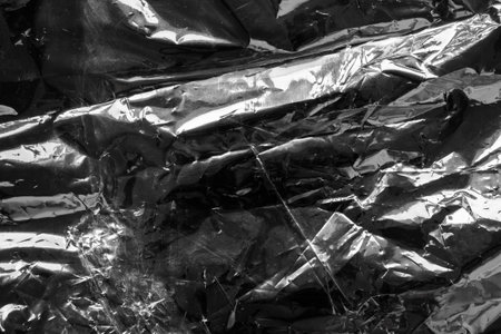 transparent plastic bag film wrap overlay texture on black backgroundの写真素材