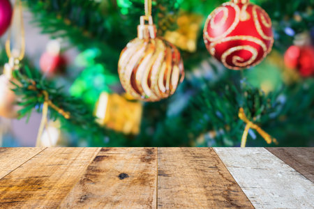 Empty wood table top with blur Christmas tree with bokeh light backgroundの写真素材