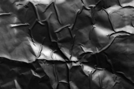 black crumpled and creased plastic poster texture backgroundの写真素材