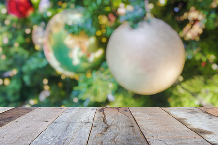 Empty wood table top with blur Christmas tree with bokeh light backgroundの写真素材