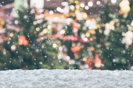 Empty white snow with blur Christmas tree with bokeh light backgroundの写真素材