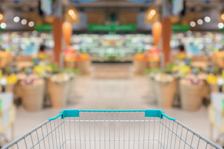 empty shopping cart in supermarket grocery store backgroundの写真素材