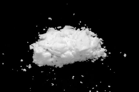 White snow isolated on black background close upの写真素材