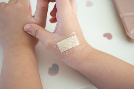 waterproof adhesive plaster on little kid hand