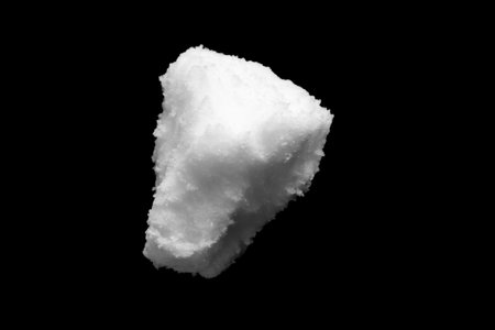 White snow isolated on black background close upの写真素材