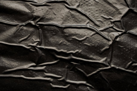black crumpled and creased plastic bag texture backgroundの写真素材