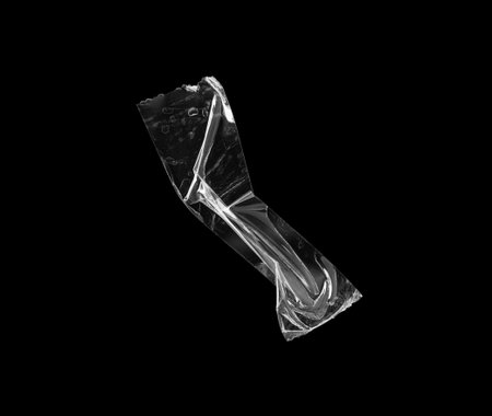 adhesive plastic tape isolated on black backgroundの写真素材